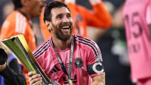 Lionel Messi smiles as he holds the Campeones Cup trophy after helping Inter Miami beat Cruz Azul