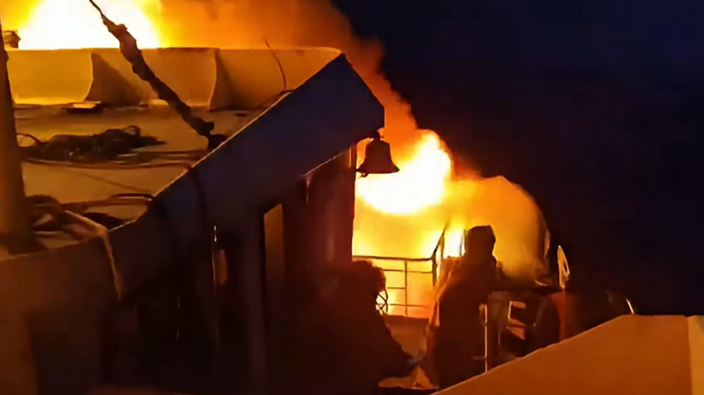 Flames engulf a ferry as a fire erupted in the night