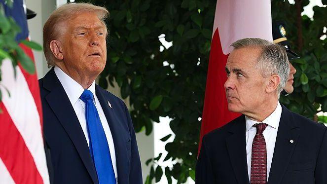 US President Donald Trump speaks to Canadian Prime Minister Mark Carney during a welcome outside the West Wing of the White House in October 2025