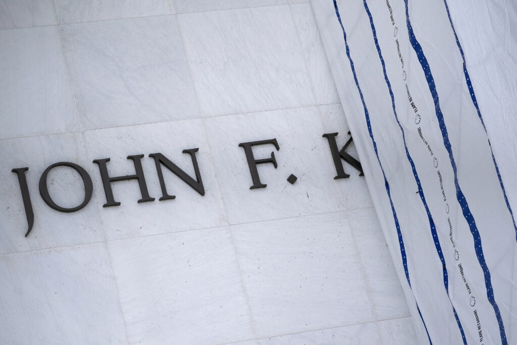 A tarp covers signage on the facade of the Kennedy Center in Washington, D.C, on June 15, 2026, after a judge ordered the removal of President Donald Trump
