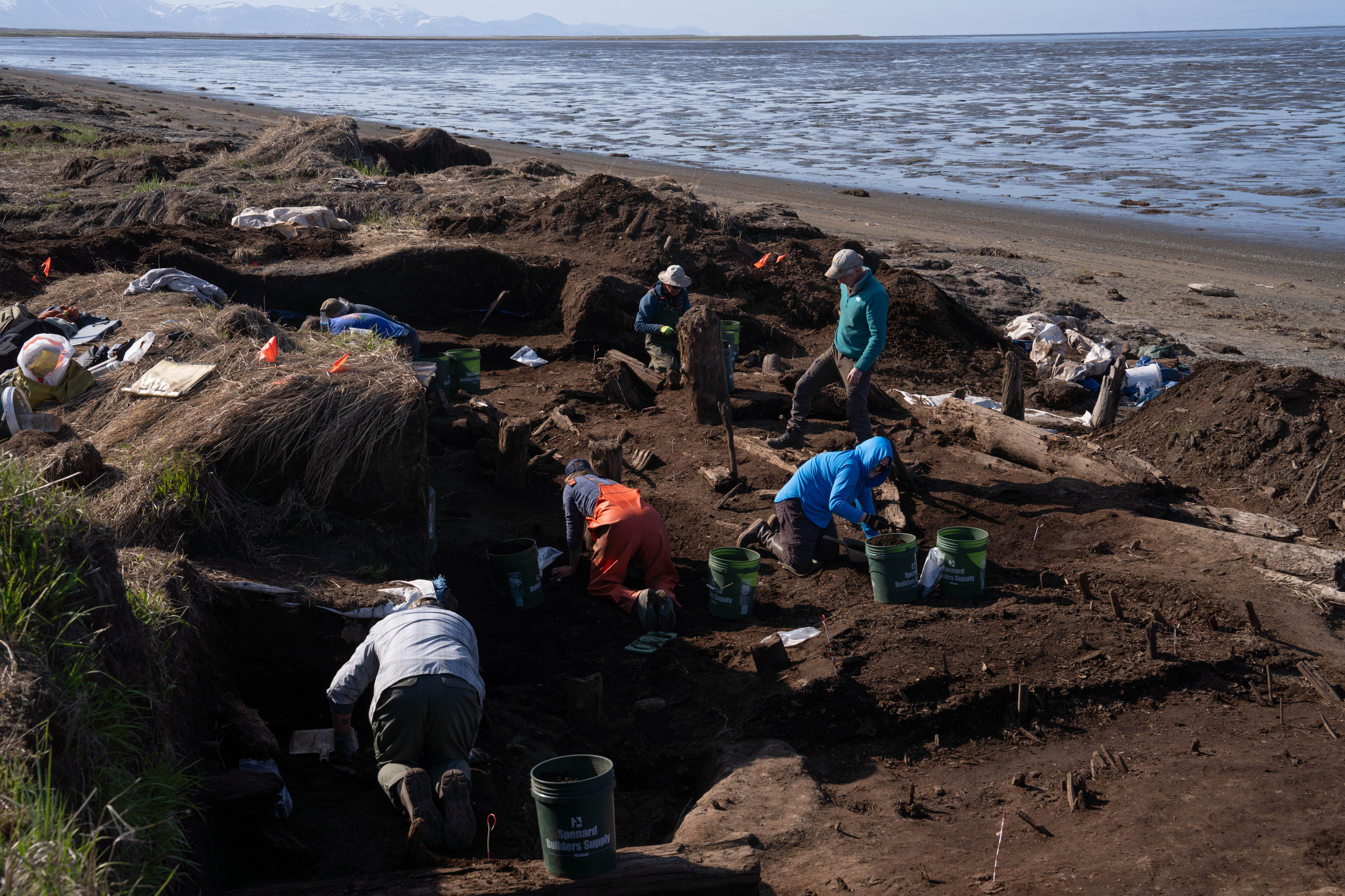 A crew of volunteer excavators and archaeologists searches the soil for artifacts at the Nunalleq dig site near the coastal village of Quinhagak, Alaska, on June 8.