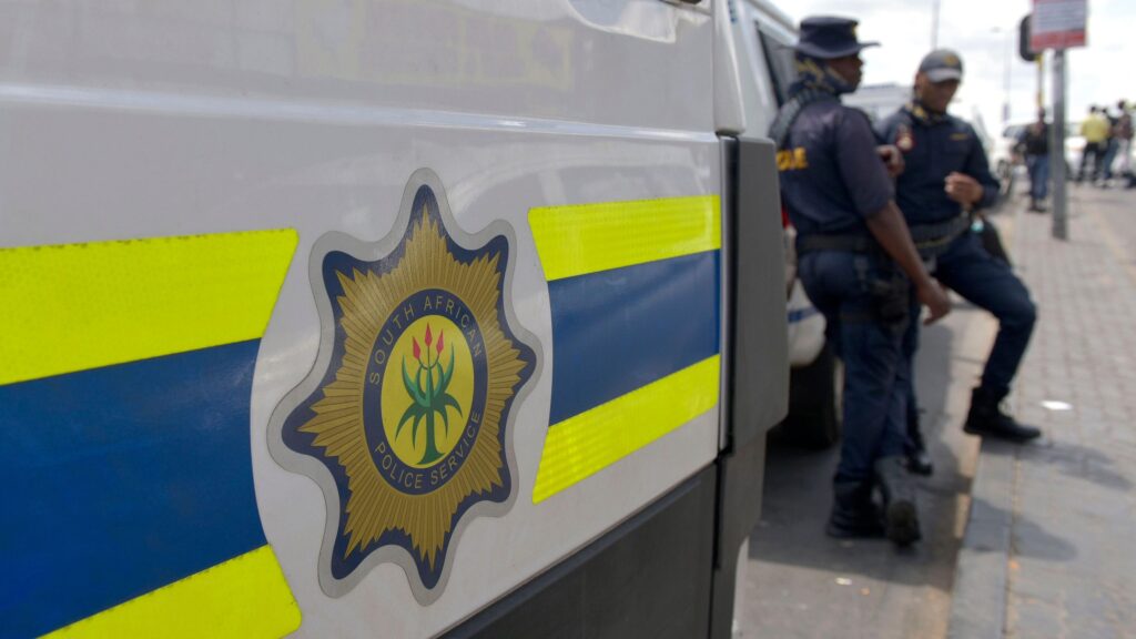 File photo of South African Police Service (SAPS) officers standing near a police van in Johannesburg