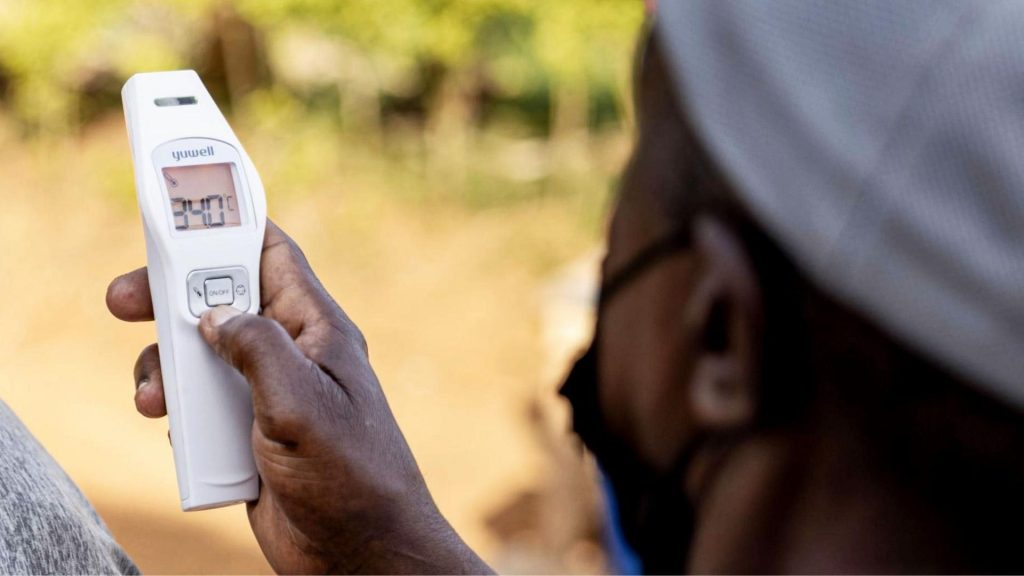 An official takes a temperature as part of Ebola preventative measures in East Africa.