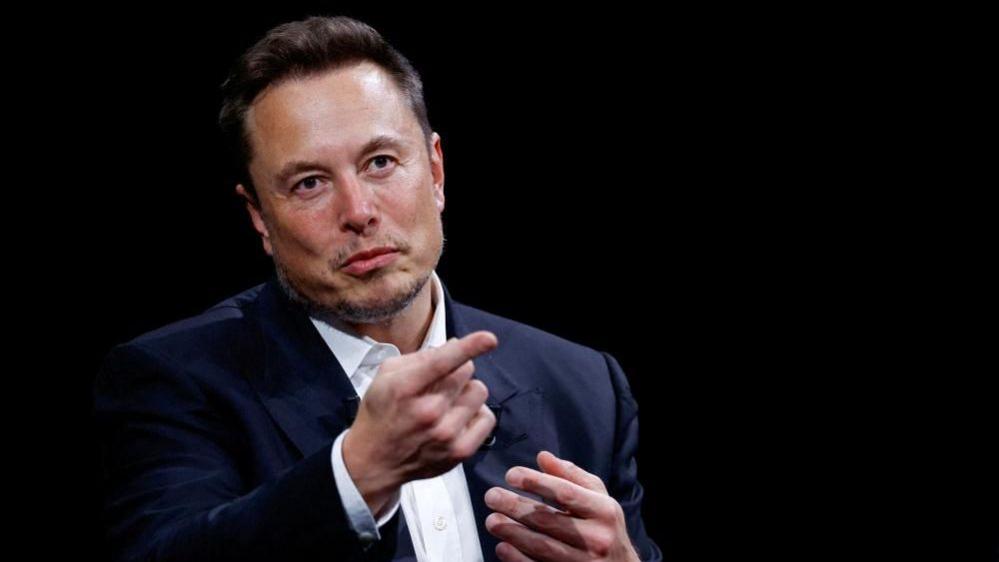 Elon Musk pointing