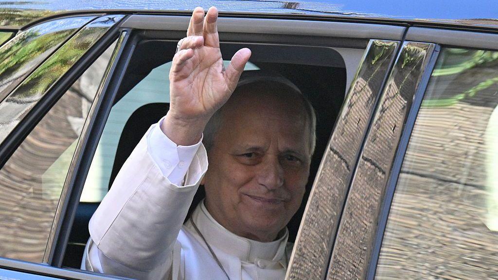 Pope Leo XIV waves from the window of a car as he leaves the Vatican before being admitted to Rome's Gemelli University Hospital for an operation to remove a lump from his lung.