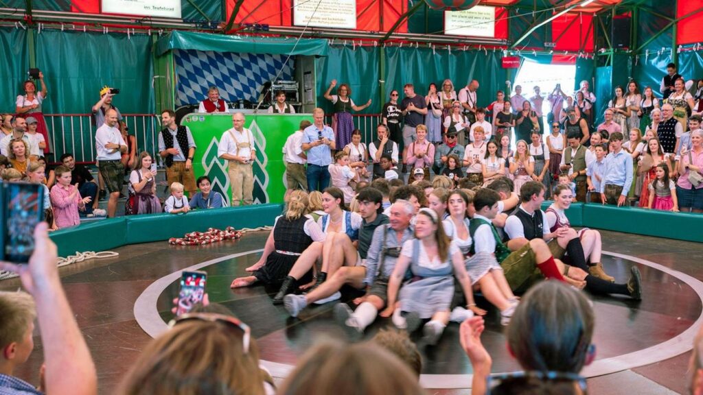 Munich, Germany. 20th Sep, 2025. Visitors sit on the Devil's Wheel at the Oktoberfest. The 190th Oktoberfest will take place from September 20 to October 5, 2025 on Munich's Theresienwiese