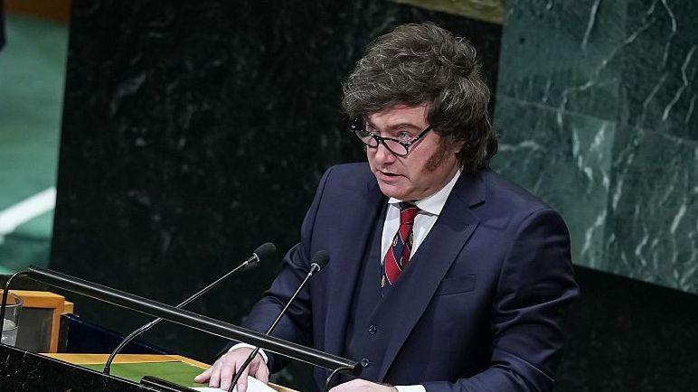 Javier Milei delivers a speech during the 81st United Nations General Assembly wearing a blue suit and red tie