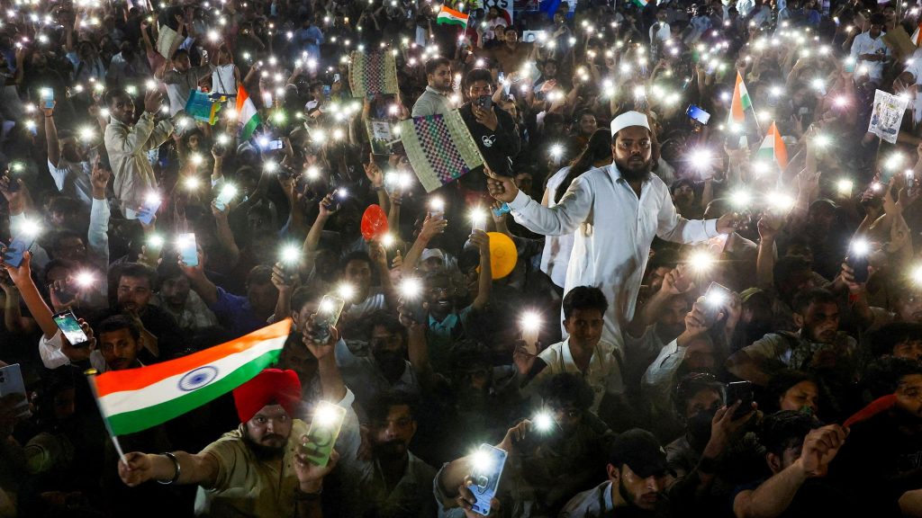 Supporters of the Cockroach Janta Party chant slogans and wave their mobile phones with their flashlights on as they gather after the Indian education reformer Sonam Wangchuk, who had been on a hunger strike, was taken to a hospital by authorities at Jantar Mantar in New Delhi on July 19, 2026.