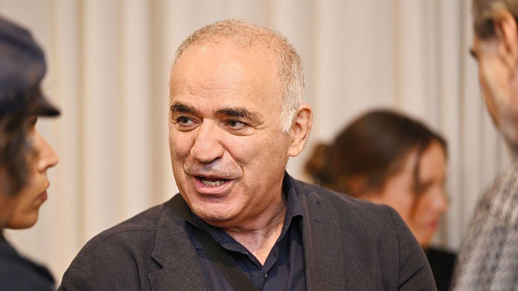 Close up of Garry Kasparov speaking at a gallery event in New York in September. He has short grey hair and is wearing a dark jacket and navy shirt.