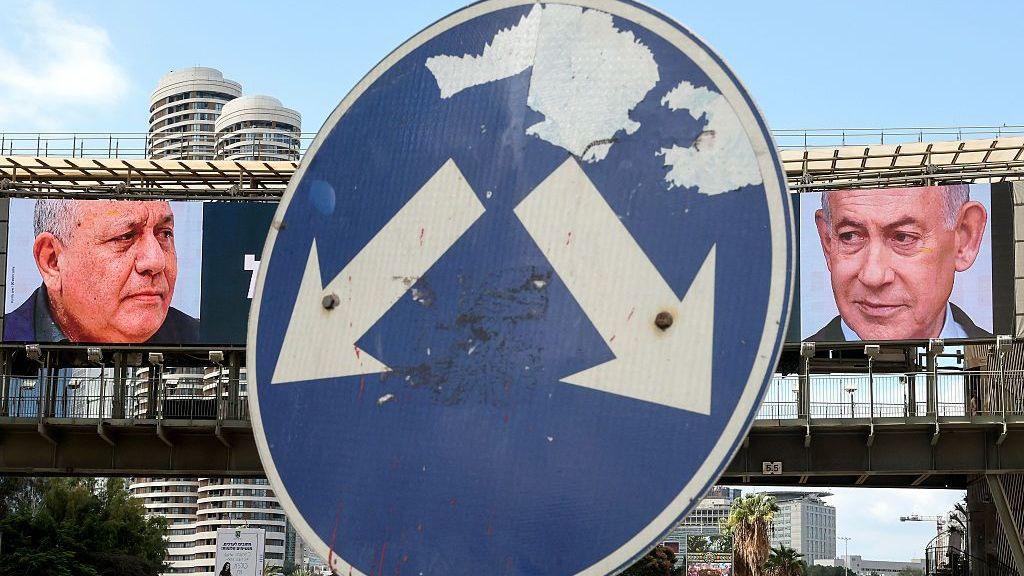 A street sign points at billboards for Eisenkot and Netanyahu.